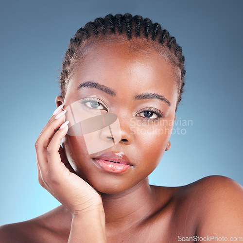 Image of Beauty, black woman and portrait with skincare, cosmetics and facial wellness in a studio. Blue background, makeup and dermatology with skin glow and shine from treatment with manicure and detox