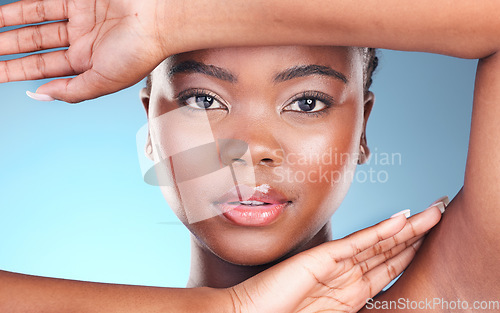 Image of Portrait, skincare and black woman with makeup, luxury and dermatology on a blue studio background. Face, African person or model with lip gloss, treatment or glow with aesthetic, shine and cosmetics