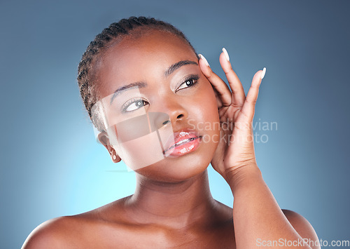 Image of Thinking, skin and face of a black woman and beauty with dermatology and natural makeup. Headshot of African person on blue background in studio with cosmetics and facial glow with hand for self care