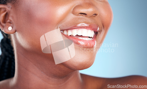 Image of Woman, teeth and smile in dental cleaning, hygiene or treatment against a blue studio background. Closeup of female person mouth in tooth whitening, oral or gum healthcare for healthy wellness