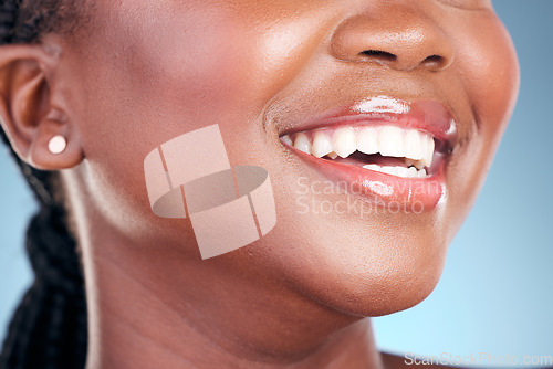 Image of Happy woman, teeth and smile in dental cleaning, hygiene or treatment against a blue studio background. Closeup of female person mouth in tooth whitening, oral or gum healthcare for healthy wellness