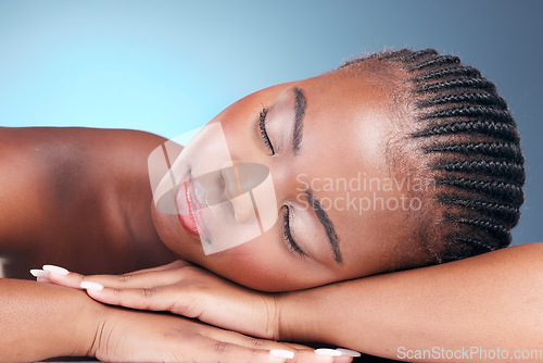 Image of Skincare, relax and black woman in studio, sleeping and natural makeup with dermatology at luxury spa. Cosmetics, rest and dream facial beauty treatment with self care on blue background in Africa.