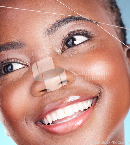 Image of Thread, eyebrow plucking and beauty of a woman with dermatology, natural makeup and smile. Face of an African person on a studio background with cosmetics, hair removal and facial glow or self care