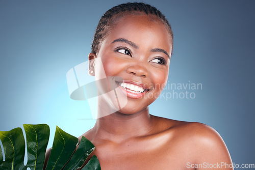 Image of Beauty, studio leaf and happy black woman with natural spa wellness, organic foundation or sustainable cosmetics. Eco product makeup, plant and African person face with monstera on blue background