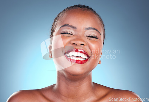 Image of Portrait, funny and black woman with beauty, makeup and cosmetics on a blue studio background. Happy person, face and model with humor, smile and dermatology with skincare, wellness and aesthetic