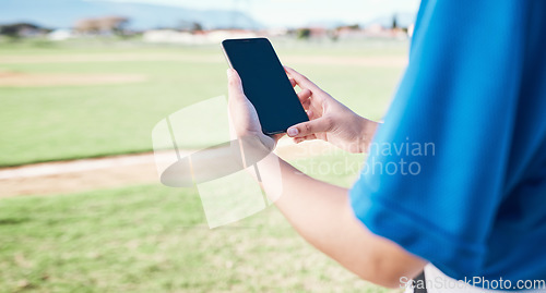 Image of App, field and person with a phone for baseball information, reading score or results after a game. Fitness, hands and an athlete with a mobile for training, connection or streaming a contest