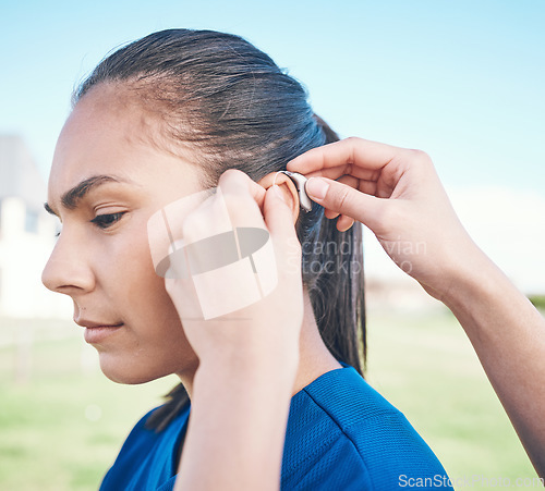 Image of Hands, profile and woman in hearing aid, ear and sound amplifier at park outdoor. Help, person with a disability and deaf tools in audio communication, wear technology and listening on microphone