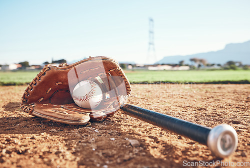 Image of Glove, bat and baseball gear on the sand for a game, professional competition or sports. Ground, fitness and equipment for a match, fitness or training for softball on the sand in summer for cardio