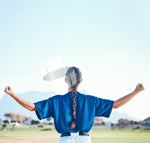 Image of Woman, fist pump and winner, softball and athlete on outdoor pitch, celebration and success with sports. Back view, baseball player and mockup space, fitness and achievement with cheers and winning