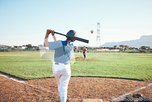 Image of Baseball, bat and person swing at ball outdoor on a pitch for sports, performance and competition. Behind athlete or softball player ready for game, training or exercise challenge at field or stadium