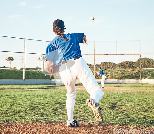 Image of Baseball, pitching and a sports person outdoor on a pitch for performance or competition. Behind professional athlete or softball player with fitness, ball and throw for game, training or exercise