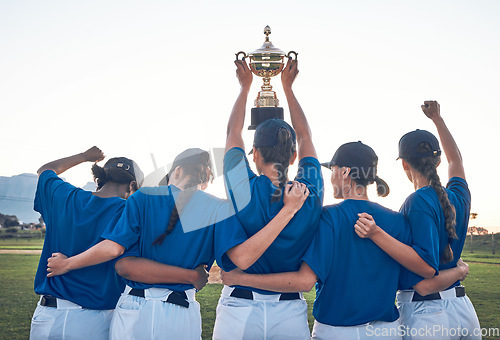 Image of Baseball, trophy and team celebrate win with women outdoor on a pitch for sports competition. Behind professional athlete or softball player group show champion prize, award or achievement at a game