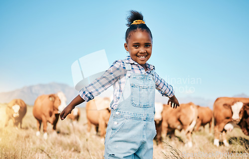 Image of Farm, cows and portrait of girl with open arms for ecology, adventure and agriculture in field. Countrysid , sustainable farming and happy African kid for freedom, relax and learning with cattle