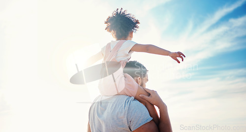 Image of Kid on father shoulders, blue sky and family with travel, back view and freedom with fun together outdoor. People in nature, sunshine and adventure, man and girl bond with tropical holiday and beach
