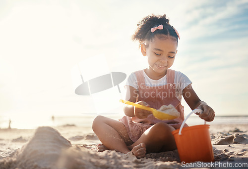 Image of Sun flare, beach and happy girl with sand, toys and vacation with happiness, playing and cheerful. Kid, shore and female child with fun, getaway trip and adventure with seaside holiday or development