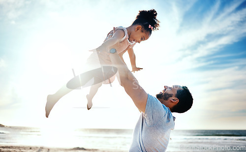 Image of Father lifting child, air and beach with family, travel and freedom outdoor, happiness and ocean with girl and man. Happy people, sunshine and tropical vacation, kid flying with dad and adventure