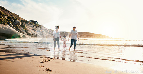 Image of Bonding, sunset and family on the beach for vacation, adventure or holiday together for bonding. Travel, walking and girl child with her mother and father on the sand by the ocean on a weekend trip.