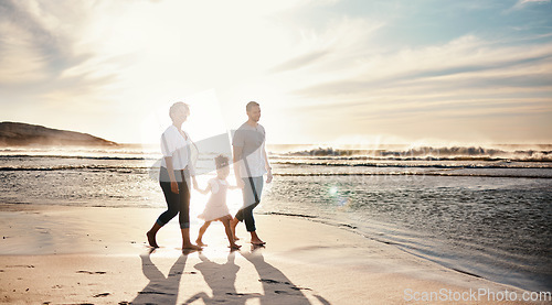 Image of Beach, sunset and family holding hands, walking and bond, relax and happy on vacation in nature together. Travel, love and girl chid with parents at ocean with freedom, adventure or journey in Bali