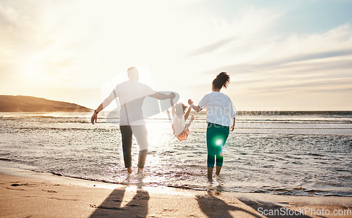 Image of Dad, mom and swing girl on beach, holiday and vacation in Florida for bonding, adventure and family together in waves. Mother, father and child at sunset in ocean, sea or playing in water for fun