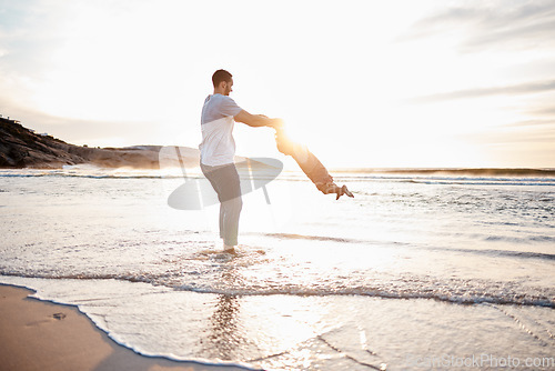 Image of Swing, beach and father with playing child holding hands in nature for freedom or bonding at sunset. Ocean, travel and parent with girl at sea for spinning fun, games or celebration adventure in Bali