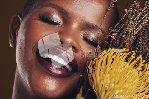 Image of Skincare, beauty and plant with the face of a black woman in studio on brown background for natural treatment. Smile, protea or cosmetics and a young model indoor for aesthetic wellness with flowers