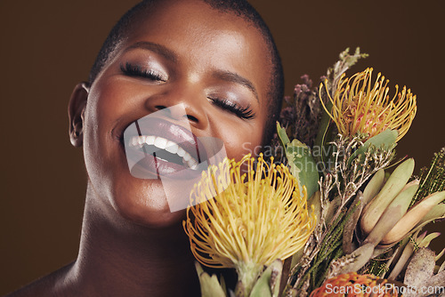 Image of Skincare, nature and plant with the face of a black woman in studio on brown background for natural treatment. Beauty, protea or cosmetics and a young model for aesthetic wellness with flowers