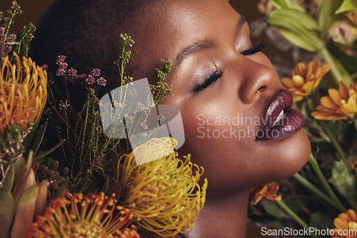 Image of Black woman, flowers and beauty with face, makeup and natural cosmetic care isolated on studio background. African model, plants and nature with sustainable skincare, eyes closed with facial and glow