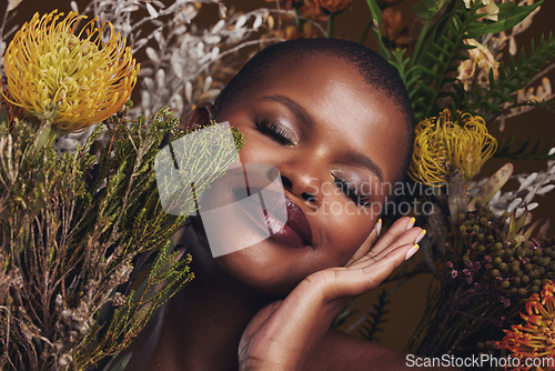 Image of Black woman, flowers and beauty with face, smile with makeup and natural cosmetics with hand touching skin. African model, plants and nature, sustainable skincare and eyes closed, facial and glow