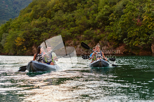 Image of A group of friends enjoying having fun and kayaking while exploring the calm river, surrounding forest and large natural river canyons