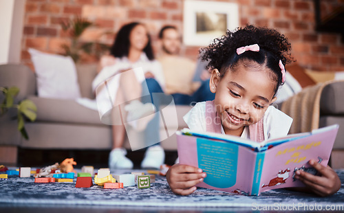 Image of Child, toys and reading in home with knowledge development and building block in living room. Family, fun and youth learning with a young girl and parents in a house together with care and bonding