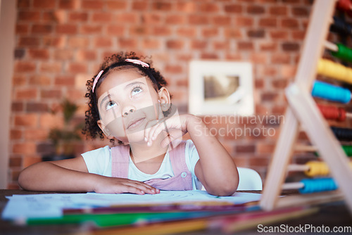 Image of Homework, thinking and child at home with study, learning and ideas for project. Young girl, problem solving and knowledge development at a house with student education and notes at table for school