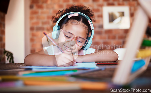 Image of Writing, headphones and child at home with music, learning and homework for school. Kid, studying and happy with radio and audio streaming in a house with listening and drawing for creative project