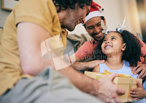 Image of Gay father, child and Christmas gift with present, house or celebration on festive holiday with smile, love or care. LGBTQ men, parents and girl kid with box, xmas fashion or culture in family home