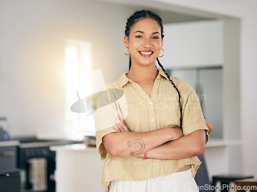 Image of Portrait, smile and arms crossed with a woman in her apartment as a proud homeowner or tenant. Brazil, relax and satisfaction with a happy young female person in the kitchen of her modern house