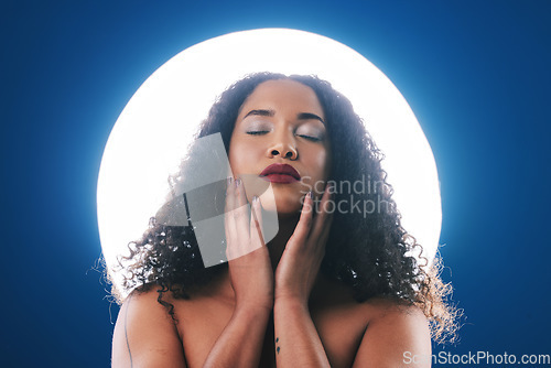 Image of Makeup, spotlight and face of woman with beauty for wellness, cosmetics and facial in studio. Neon circle, creative salon and person for skincare, glamour or aesthetic on blue background for art deco