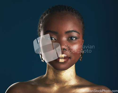 Image of Gold makeup, studio portrait or black woman with creative art, facial cosmetics paint and lipstick. African culture, face glow and person with beauty design, wellness or creativity on blue background