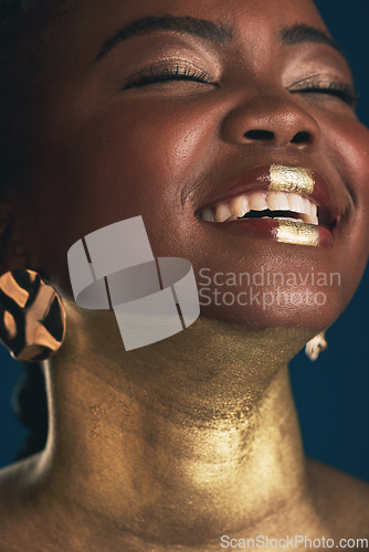 Image of Smile, gold and makeup with face of black woman in studio for creative, luxury and cosmetics. Glow, glamour art and beauty with model on dark background for elegant, skincare and salon treatment