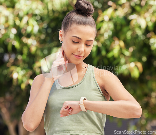 Image of Woman, watch and fitness for pulse, heart rate or monitoring performance after outdoor workout. Happy female person, runner or athlete checking wristwatch on break or rest from exercise in nature