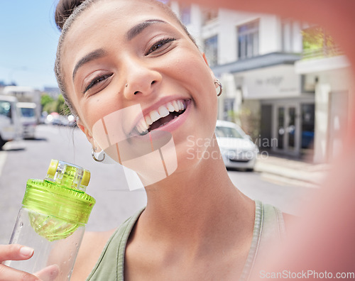 Image of Fitness selfie, portrait and woman with water in the city after running, exercise or outdoor cardio. Smile, health and face of a female runner or athlete taking a picture after a workout with a drink