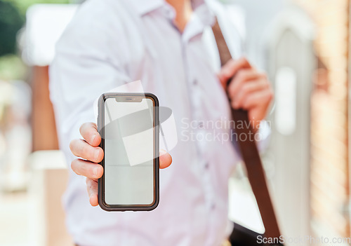 Image of Hand, phone and mockup with a business man in the city on his morning commute into work closeup. Mobile, app or communication with an employee showing blank space on a screen or display outdoor