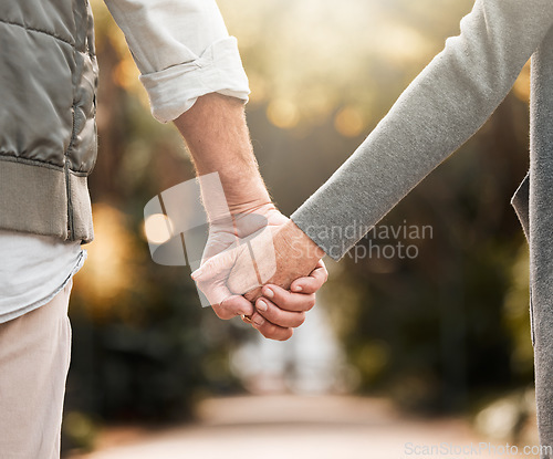 Image of Love, park and relax couple holding hands, bonding and enjoy quality time together, freedom and nature wellness. Support, marriage and closeup people on romantic date, outdoor walk or Valentines Day