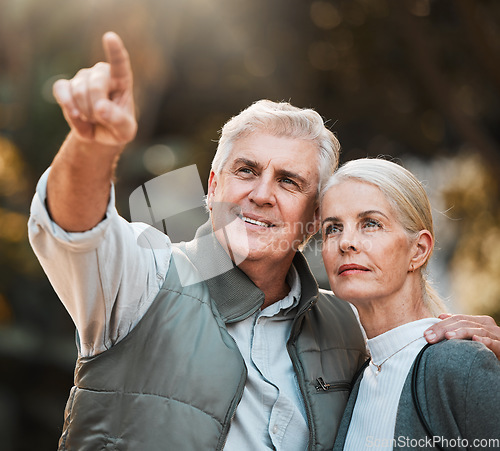 Image of Senior couple, hiking and pointing in nature, thinking and view with direction, forest and adventure. Elderly man, woman and together with vision, walk or check environment on outdoor holiday in park