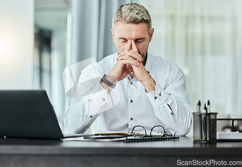 Image of Stress, burnout and headache with a business man in the office, working on a laptop for a report deadline. Anxiety, mental health and tax with a manager overwhelmed by bankruptcy or financial crisis