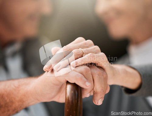 Image of Holding hands, couple and a cane in nature for love, bonding and support. Peace, closeup and a senior man and woman in a park with a walking stick, care and together in a garden with trust on a date