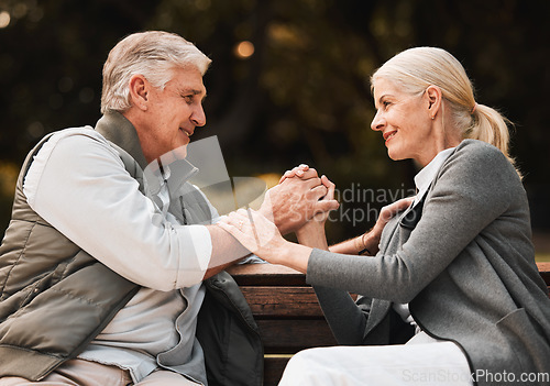 Image of Love, park bench and senior happy couple holding hands, bond and enjoy time together, freedom and connect in garden. Eye contact, trust and support of old man, woman or marriage people on nature date