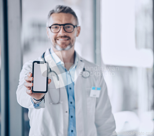 Image of Doctor, phone screen and mockup for healthcare presentation, communication or FAQ in hospital. Medical portrait of man with mobile app, advertising or ux design space for contact us or clinic sign up