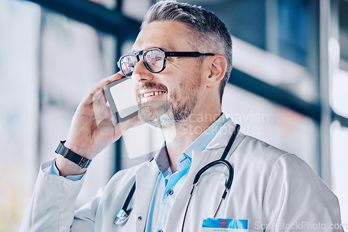 Image of Thinking, smile and a doctor or man on a phone call for communication, healthcare advice or contact. Happy, idea and a mature medical employee speaking on a mobile for help with medicine work