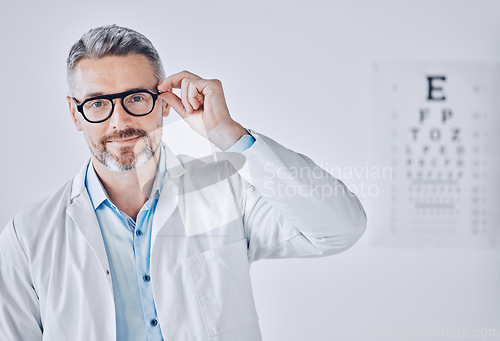 Image of Portrait, glasses and eye exam with an optometrist man in his office for healthcare or vision improvement. Medical, frame and eyewear with a doctor or optician in a clinic for assessment and testing