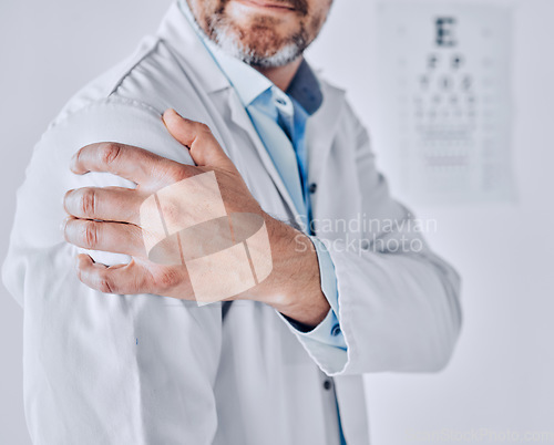 Image of Doctor man, shoulder pain and hand with stress injury, fatigue and burnout at optometry job in clinic. Ophthalmologist, emergency or accident with muscle, bone or joint with massage in hospital