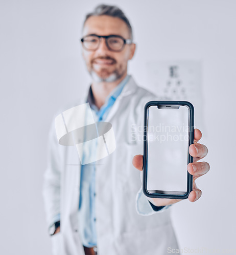 Image of Phone, screen and optometrist in eye exam, test or booking an assessment for vision with mobile app, internet or website. Cellphone, mockup and doctor testing eyesight in office with technology